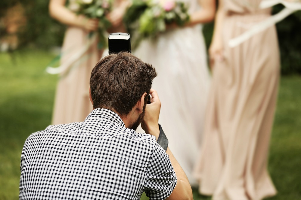 Jak wybrać fotografa ślubnego - fotograf robi zdjęcia druhnom.