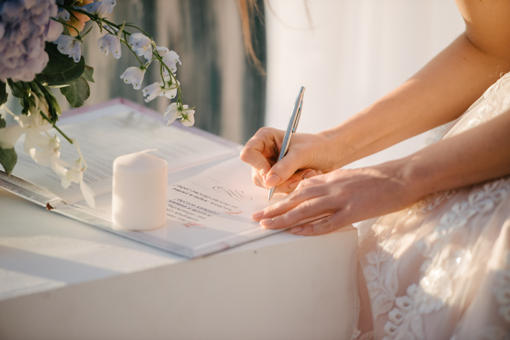 Protokół przedślubny - panna młoda podpisująca dokumenty 