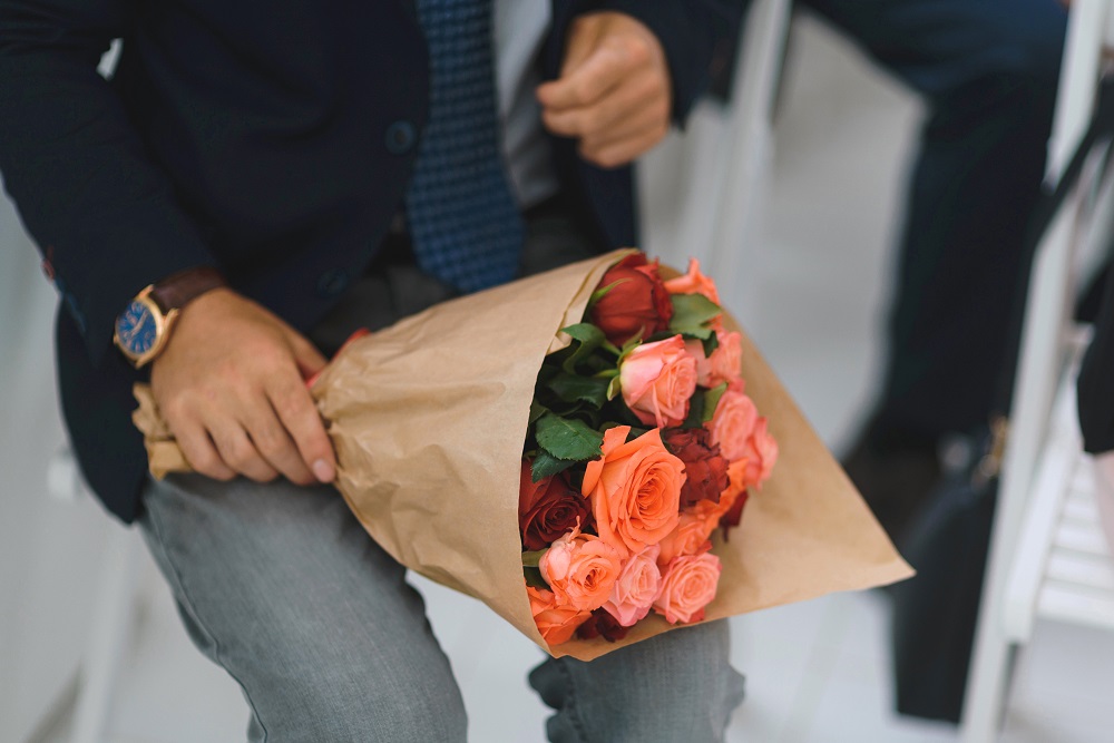 Kwiaty na zaręczyny - mężczyzna trzyma bukiet róż