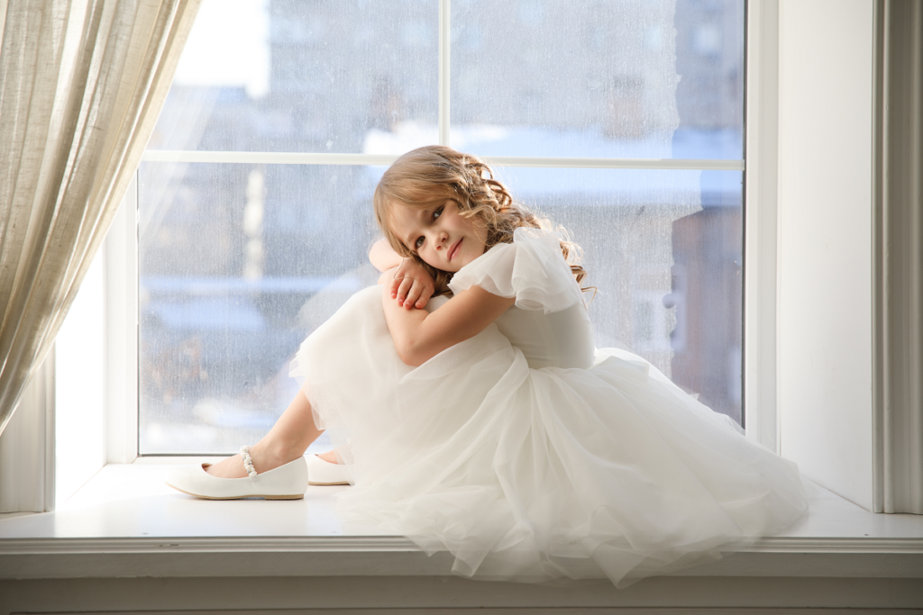 Sukienki dla dziewczynek na wesele - mała dziewczynka w białej sukience z tiulu 